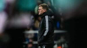Newcastle head coach Eddie Howe standing seriously during a Premier League match
