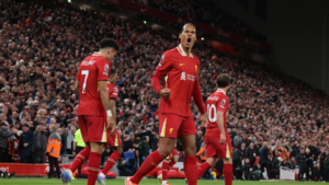 Liverpool players Virgil van Dijk, Luiz Diaz and Alexis Macallister at Anfield at night after scoring a goal