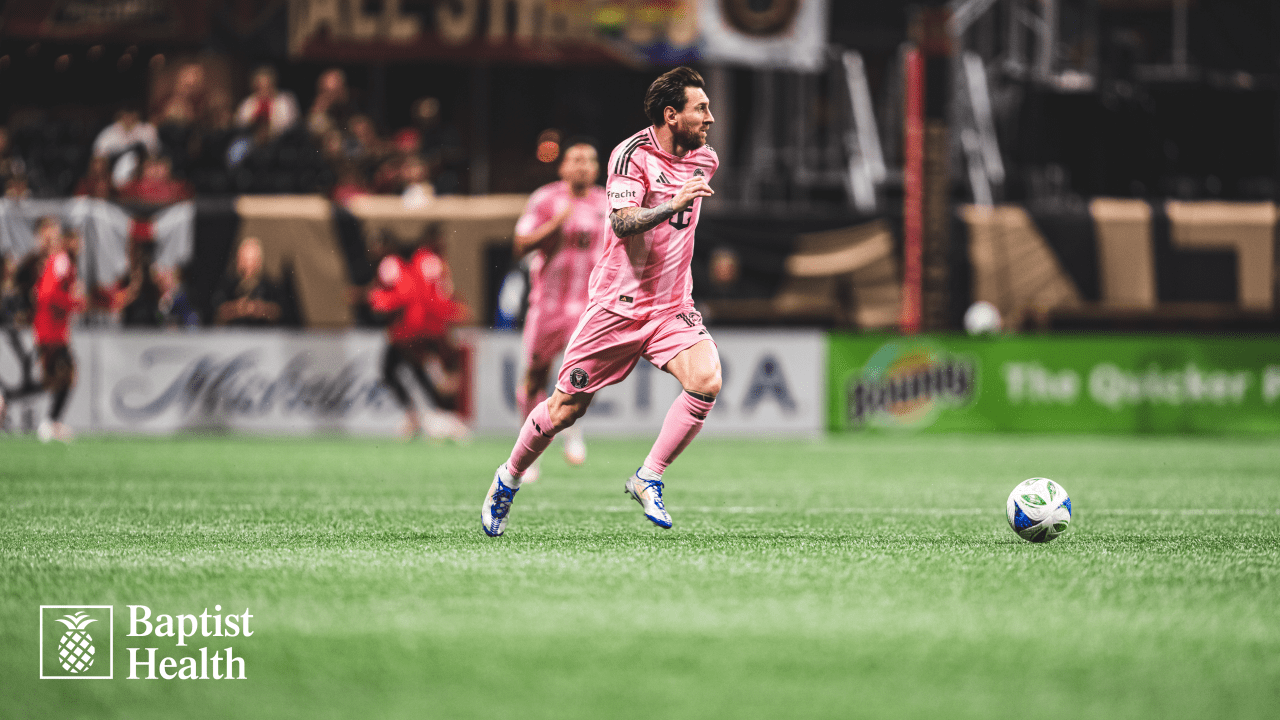 Inter Miami player Lionel Messi running the ball during a football match