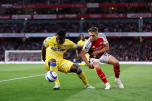 Arsenal player Leandro Trossard vying for the ball with Crystal Palace player
