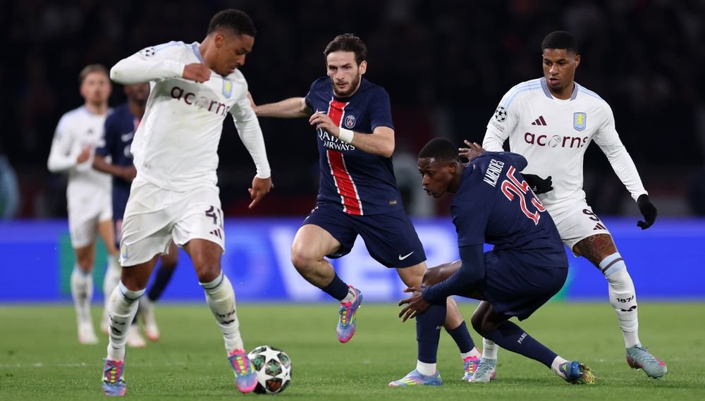 Aston Villa and PSG players vying for the ball in Paris stadium