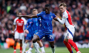 Chelsea player Moises Caicedo vying for the ball with Arsenal player