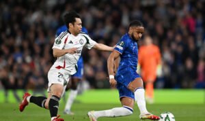 Chelsea player Christopher Nkunku vying for the ball with a Legia player