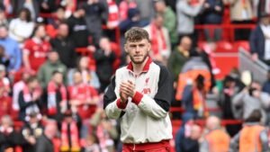 Liverpool defender Connor Bradley clapping fans after a win at Anfield