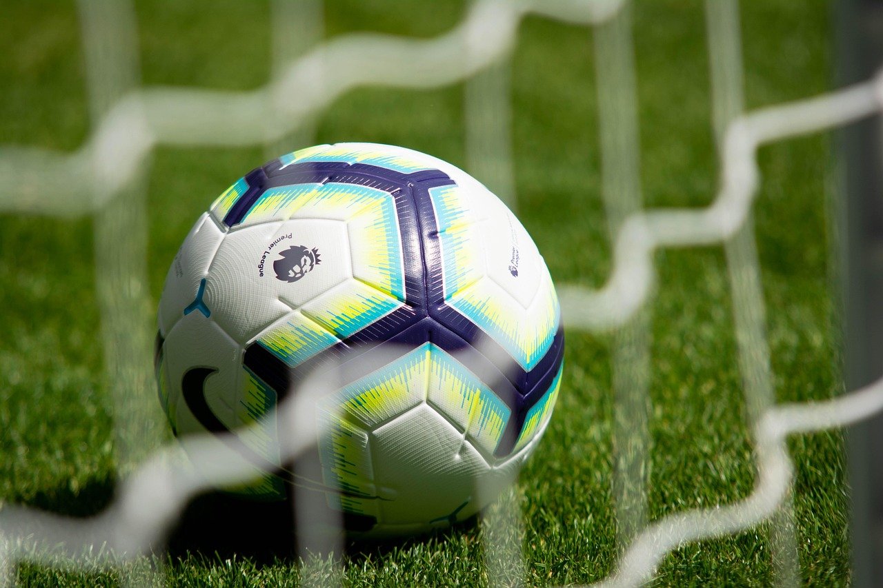 Premier League football beside a net