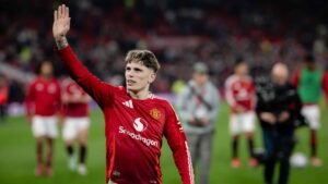 Manchester United player Alejandro Garnacho waving to fans at Old Trafford