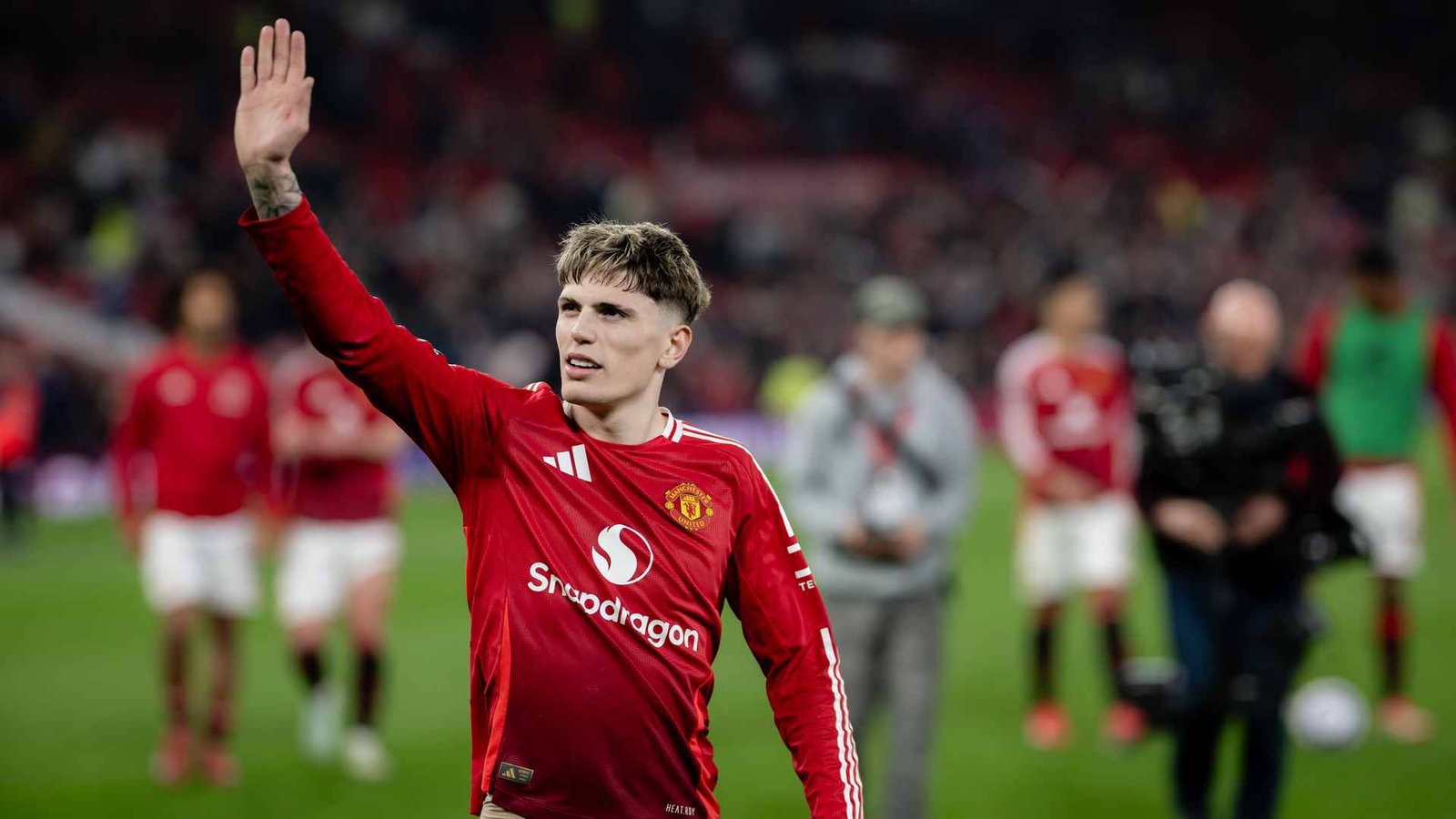 Manchester United player Alejandro Garnacho waving to fans at Old Trafford