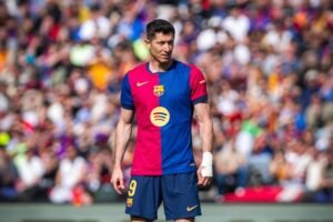 Barcelona forward Lewandowski watching on during a football match
