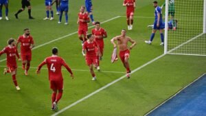 Liverpool team celebrating after Trent Alexander-Arnold scored a winner against Leicester City at the King Power Stadium