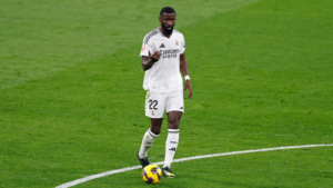Real Madrid defender Antonio Rudiger with the ball on a pitch
