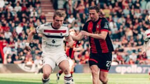 Manchester United striker Rasmus Hojlund competing against Bournemouth player at the Vitality Stadium