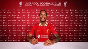 Liverpool player Van Dijk signing a contract