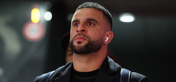 Ac Milan defender Kyle Walker standing and staring ahead with dark background