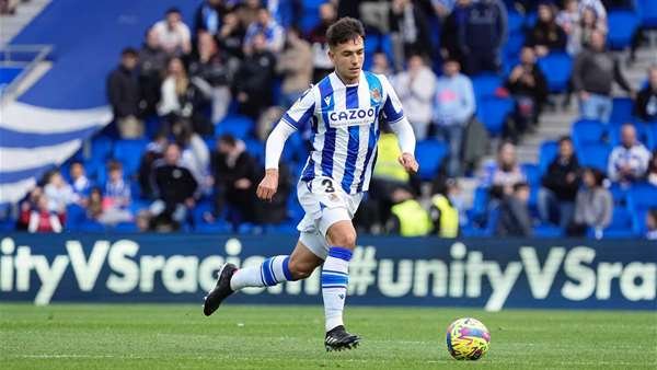 Arsenal target Zubimendi running with the ball in a stadium