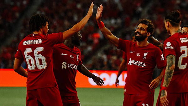 Liverpool players Mohamed Salah and Trent Alexander-Arnold celebrating a goal