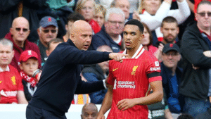 Liverpool right-back Trent Alexander-Arnold receiving instructions from coach Arne Slot