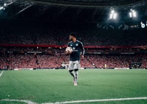 Manchester United player Amad going to take a corner kick in a stadium