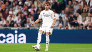 Real Madrid player Ascencio passing the ball during a match
