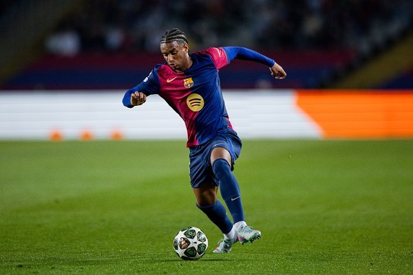 Barcelona defender Alejandro Balde running with the ball during a football match