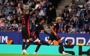 Barcelona forward Lamine Yamal celebrating with teammates after scoring a goal against Espanyol