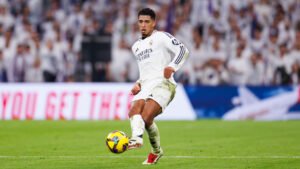 Real Madrid midfielder Jude Bellingham passing the ball during a match at the Santiago Bernabeu stadium
