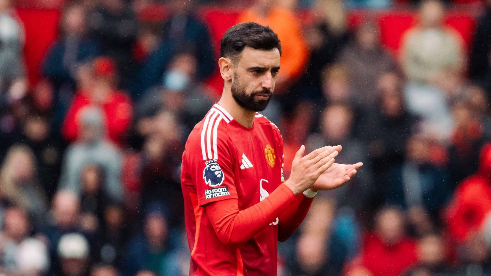 Bruno Fernandes clapping on the pitch after a Premier League match