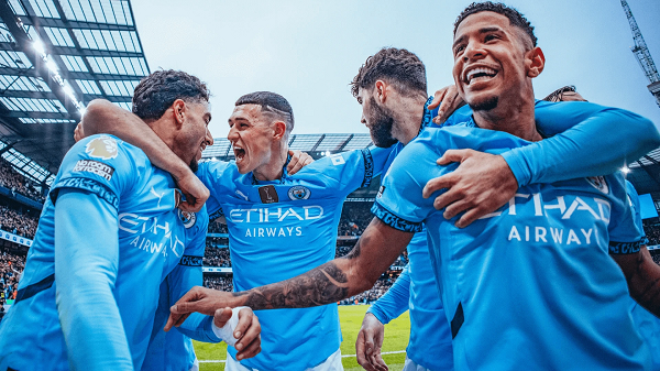 Manchester City players celebrating a goal at the Etihad Stadium