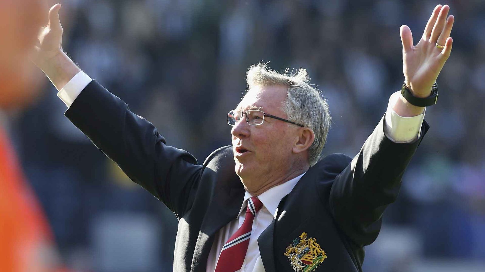 Former Manchester United manager Alex Ferguson saluting the crowd at Old Trafford