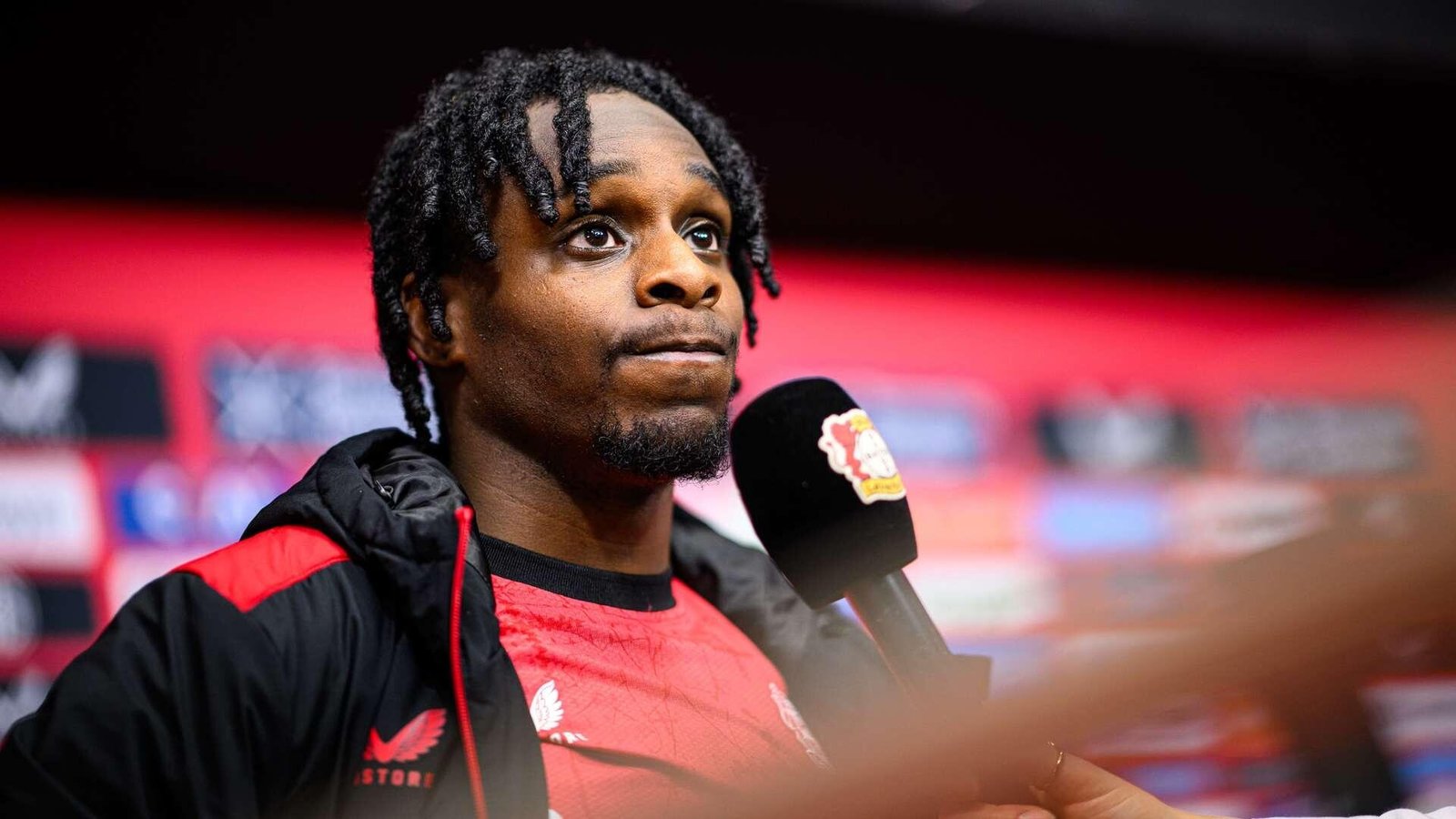 Bayer Leverkusen defender and Liverpool target Jeremie Frimpong speaking during a press conference