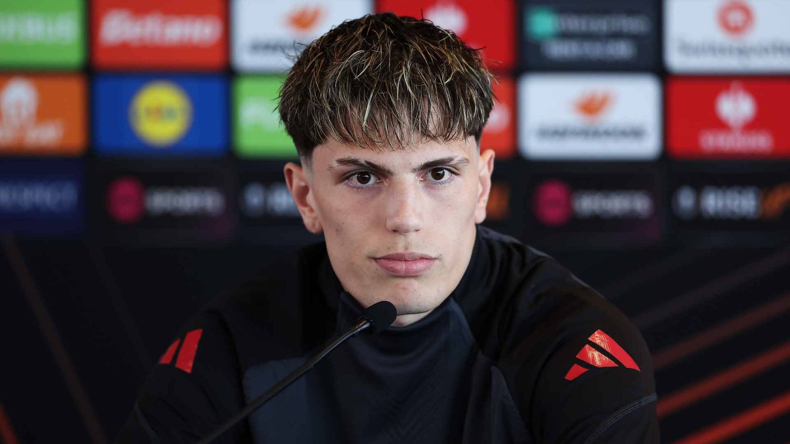 Manchester United player Alejandro Garnacho sitting at a press conference