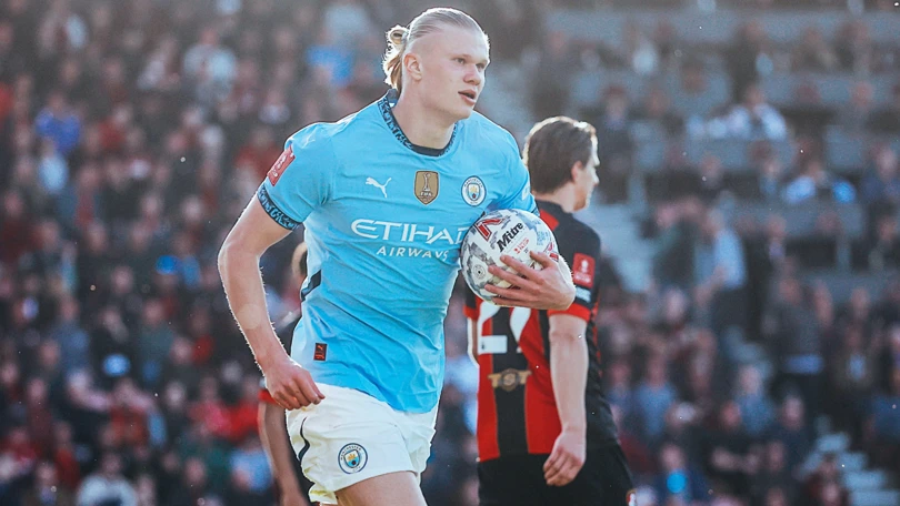 Manchester City forward Erling Haaland celebrating with the ball after a goal
