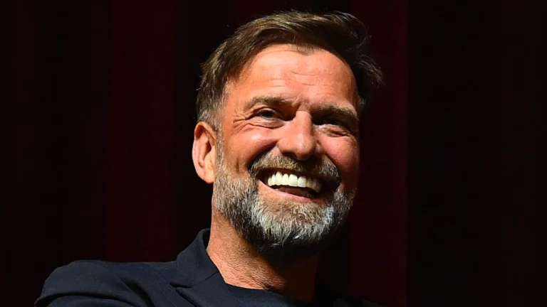 Former Liverpool manager Jurgen Klopp smiling against a dark background