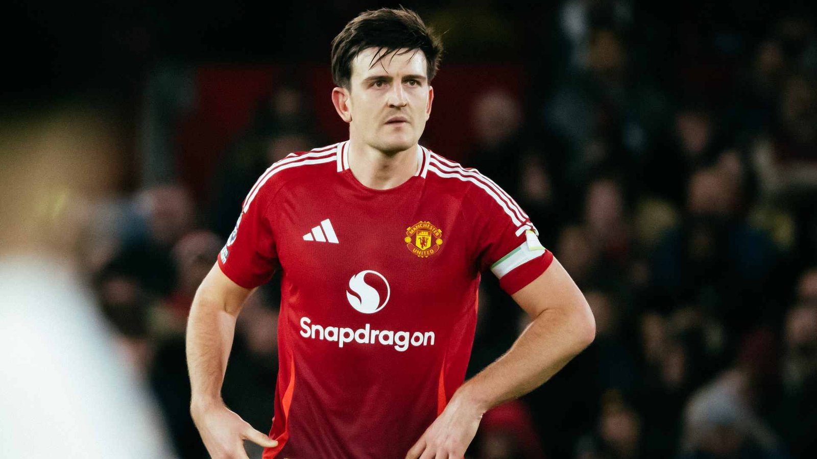 Manchester United defender Harry Maguire standing in a stadium during a match