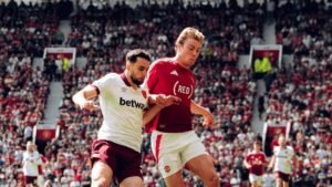 Manchester United striker Rasmus Hojlund vying for the ball with his West Ham opponent