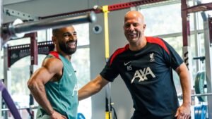 Mohamed Salah and Arne Slot laughing at Liverpool AXA training centre