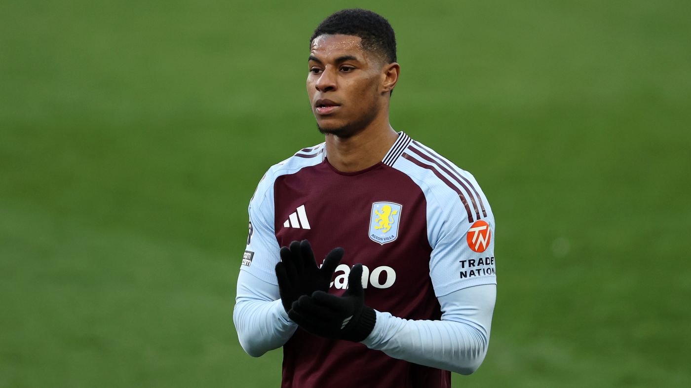 Marcus Rashford applauding on a football pitch in an Aston Villa jersey