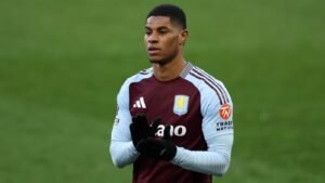 Barcelona target Marcus Rashford walking at Villa Park in an Aston Villa shirt