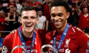Andy Robertson and Trent Alexander-Arnold posing with Champions League trophy after winning the competition in 2019