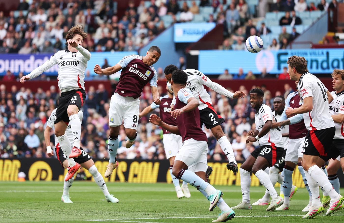 Aston Villa midfielder Youri Tielemans heading the ball against Fulham