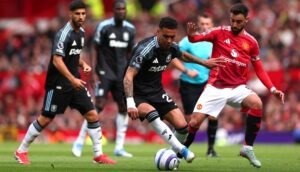 Aston Villa and Manchester United players vying for the ball at Old Trafford