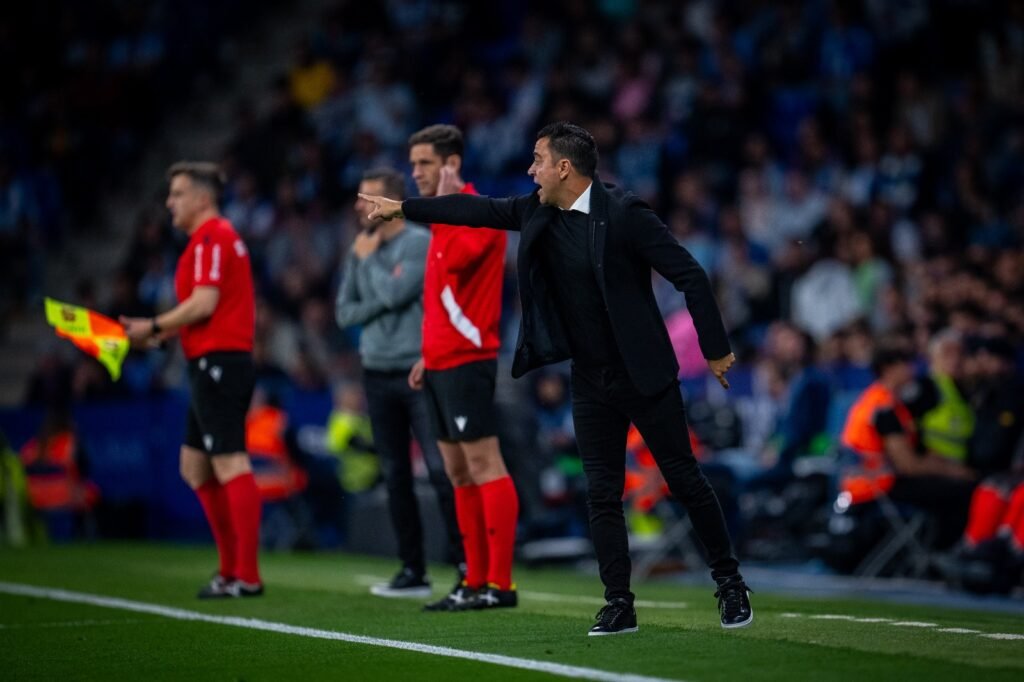 Barcelona coach Xavi directing play from the sidelines during a match