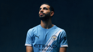Rayan Ait-Nouri posing in a Manchester City shirt