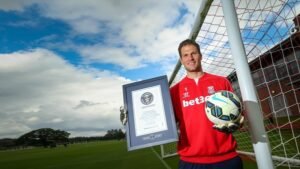 Stoke City goalkeeper Asmir Begovic holding a Guinness Book of Records certificate