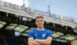 Liam Delap posing at Stamford Bridge after his signing was made official.