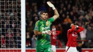 Emiliano Martinez raising a hand during a football match for Aston Villa