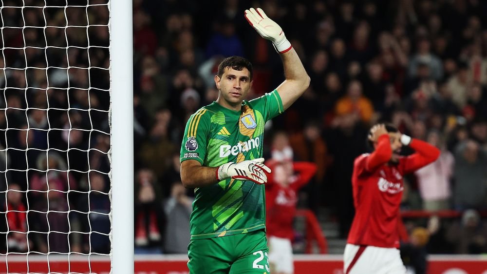 Emiliano Martinez raising a hand during a football match for Aston Villa