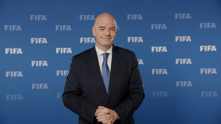 Gianni Infantino in front of a board with Fifa logos