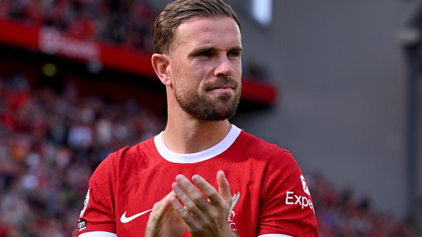 Jordan Henderson applauding fans during a Liverpool game at Anfield.