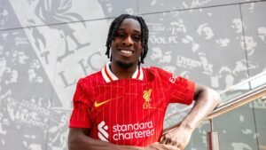 Jeremie Frimpong posing in a Liverpool shirt