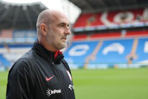 Poland manager Michal Probierz standing in an empty stadium